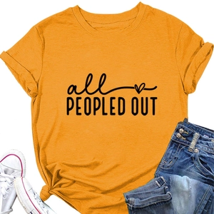 Detail of all PEOPLED OUT slogan on mustard yellow cotton T-shirt with denim jeans