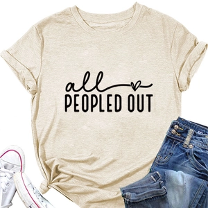 Flat lay of beige 'all PEOPLED OUT' graphic tee with jeans and white canvas sneakers