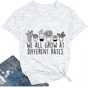 Close-up of succulent print and We All Grow At Different Rates text on gray tee