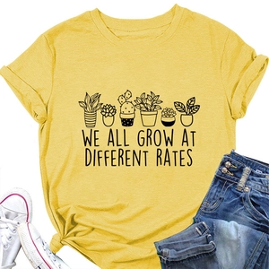 Detail of ginger yellow t-shirt with plants print and We All Grow At Different Rates text