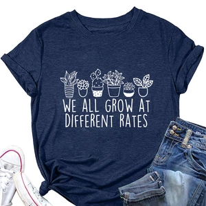 Detailed close-up of dark blue cotton T-shirt with succulent plants and motivational quote