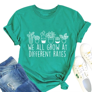 Flat lay of teal cotton T-shirt with succulent print and we all grow at different rates text