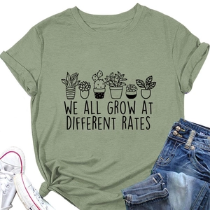 Flat lay of green plant graphic T-shirt with casual denim jeans and white sneakers