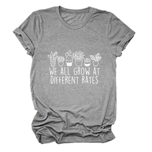 Detail of grey t-shirt with we all grow at different rates plant print on cotton fabric