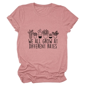 Detail of succulent print and We All Grow At Different Rates text on pink cotton T-shirt