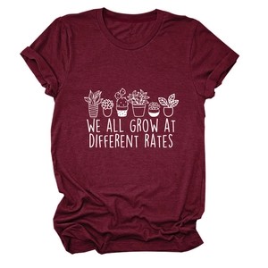 Close-up of wine red t-shirt with rolled sleeves and botanical inspirational print