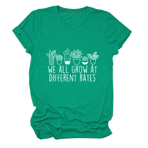 Close-up of emerald green t-shirt featuring potted plants and motivational text print