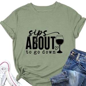 Détail du t-shirt vert sauge avec imprimé vin et ourlet noué élégant sur le devant