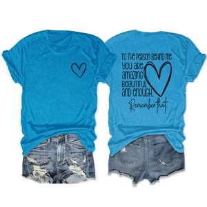 Détail du t-shirt bleu avec imprimé cœur au dos et de la citation avec le short en jean