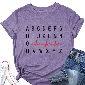Close-up of purple t-shirt featuring heart rate line and alphabet graphic design