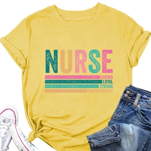 Flat lay of yellow nurse t-shirt with caring loyal strong print and white sneakers