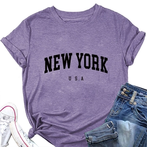 Flat lay of purple New York USA graphic t-shirt with jeans and canvas sneakers