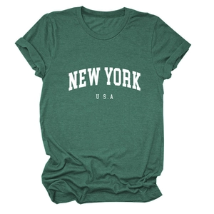 Detailed macro view of the New York USA print on vintage green cotton T-shirt fabric