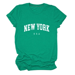 Close-up of the New York USA white graphic print on a green cotton crewneck t-shirt