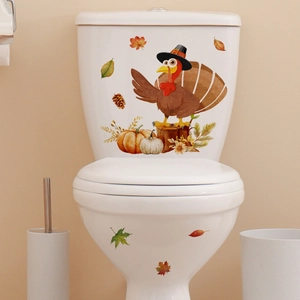 Thanksgiving turkey and pumpkin wall stickers on a white toilet with fall leaves