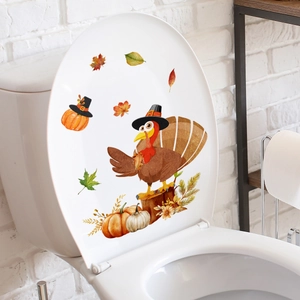 Detailed view of Thanksgiving turkey and pumpkin stickers on a white toilet lid cover