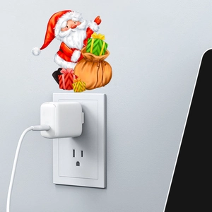 Adesivo natalizio di Babbo Natale fluorescente applicato sopra l'interruttore della luce
