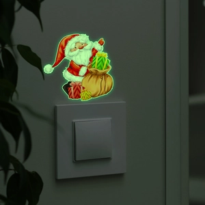 Adesivo interruttore Babbo Natale luminoso con luce verde in un ambiente buio