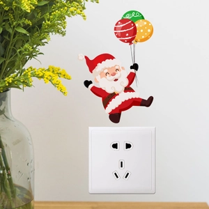 Adesivo murale Babbo Natale luminoso posizionato sopra un interruttore della luce