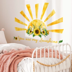 Detail of sunflower wall sticker with You Are My Sunshine quote in cozy bedroom decor