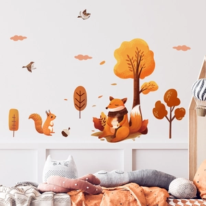 Cozy nursery wall decals with foxes, squirrels and autumn trees above a child's bed