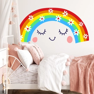 Detailed view of colorful rainbow wall decal with daisies and cute smiling face on white wall