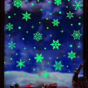 Luminous green snowflake and star window stickers glowing in dark winter scene