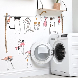 Detail of cute cartoon cat and fish wall decals in a modern laundry room setting