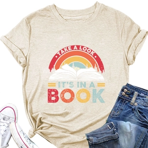 Flat lay of beige T-shirt with rainbow book graphic and Take A Look It's In A Book slogan