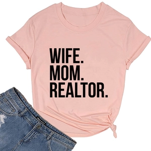 Flat lay of light pink cotton T-shirt with Wife Mom Realtor print and side knot detail