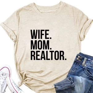 Flat lay of apricot Wife Mom Realtor t-shirt with knotted hem and denim jeans
