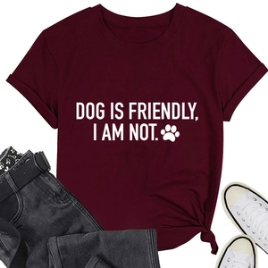 Flat lay of burgundy cotton T-shirt with 'DOG IS FRIENDLY' print and denim jeans