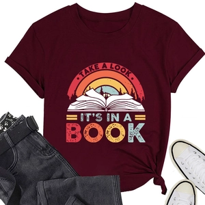 Flat lay of burgundy t-shirt with retro book print, paired with jeans and shoes