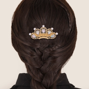 Elegant gold crown hair clip with pearls and rhinestones shown on braided hair
