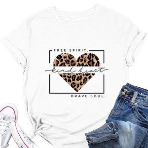 Flat lay of white T-shirt with leopard heart print styled with denim shorts and sneakers
