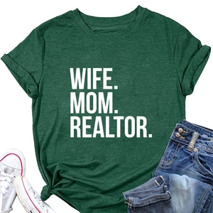 Flat lay of dark green T-shirt with WIFE MOM REALTOR print and casual outfit accessories