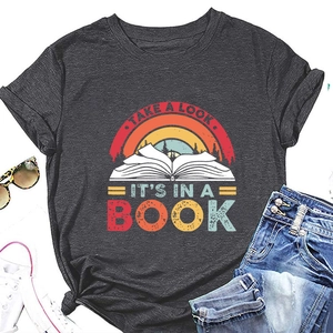 Flat lay of women's dark grey T-shirt with rainbow book print and casual accessories