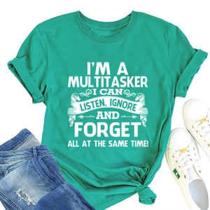 Flat lay of mint green cotton t-shirt with slogan print and denim shorts outfit