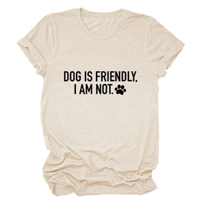 Close-up of beige crew neck t-shirt featuring dog slogan and black paw print graphic