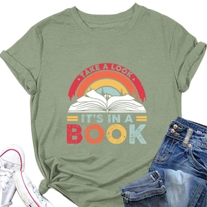 Detail of vintage book graphic and colorful lettering on pea green cotton t-shirt