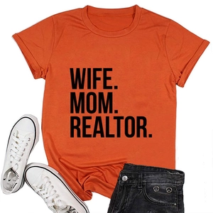 Flat-lay view of orange Wife Mom Realtor T-shirt styled with denim shorts and sneakers