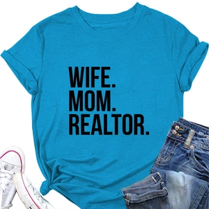 Flat lay of blue T-shirt with Wife Mom Realtor print, denim shorts and canvas sneakers