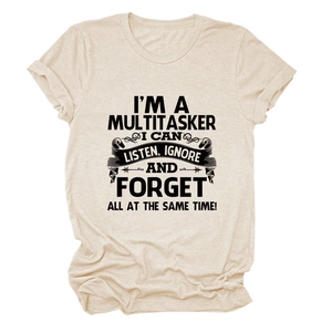 Close-up of I'm a Multitasker slogan print on oat-colored cotton blend t-shirt fabric