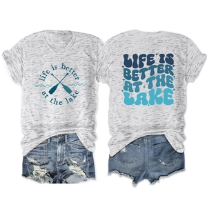 Detail of grey Life is Better at the Lake t-shirt with blue distressed denim shorts