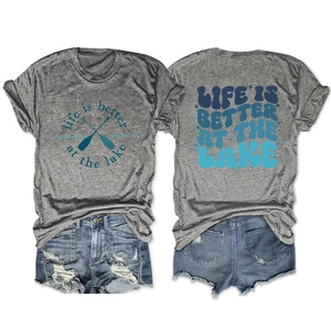 Detail view showing gray Life is Better at the Lake t-shirt and ripped denim shorts