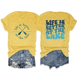 Flat lay of yellow lake-themed t-shirt with back and front view and denim shorts