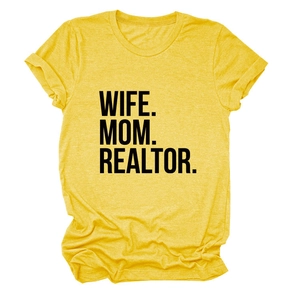 Close-up of WIFE MOM REALTOR bold text print on heather yellow cotton t-shirt