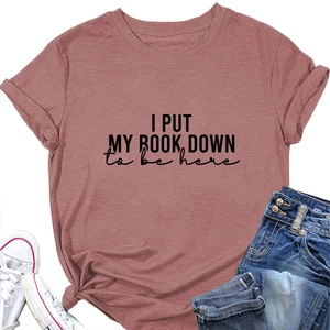 Detail of pink cotton T-shirt with I PUT MY BOOK DOWN text print and rolled sleeves