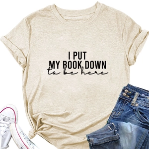Detail of cotton beige T-shirt with 'I PUT MY BOOK DOWN' print and casual texture