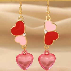 Golden heart drop earrings with pink resin charms and red enamel for Valentine's Day